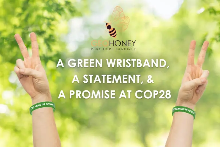 Two UAE leaders wearing green wristbands, the official COP28 conference wristband made of sustainable and recyclable materials.